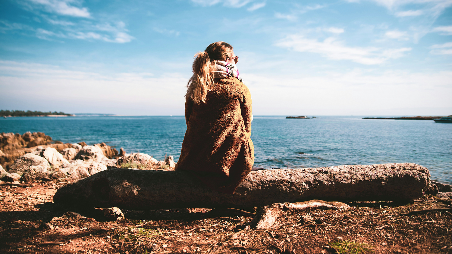 Woman contemplating looking out over water