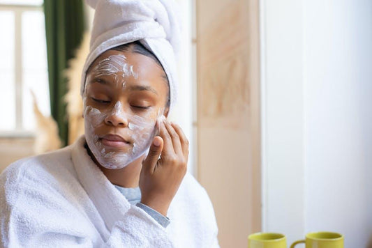 Woman applying self-care products to her face